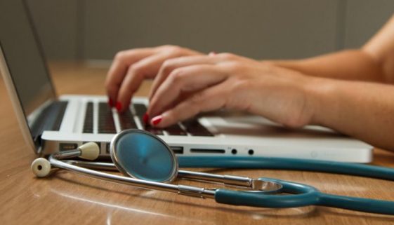 Photo of a doctor and her laptop by National Cancer Institute on Unsplash