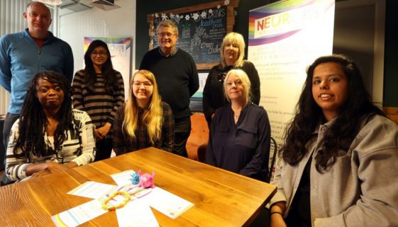 a group of people sitting and standing together