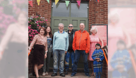 MHT - for world mental health day a group of people in front of a door outside a building