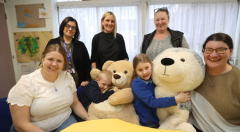 a group of children, parents and teachers, together around a table