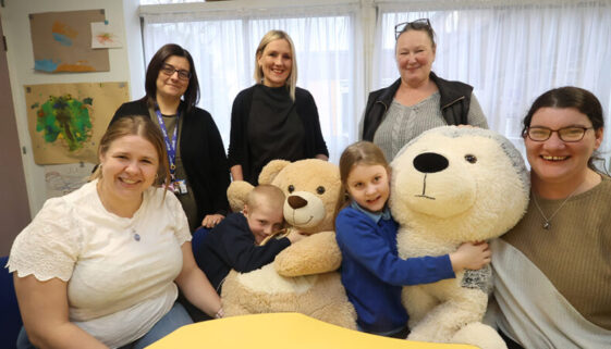 a group of children, parents and teachers, together around a table