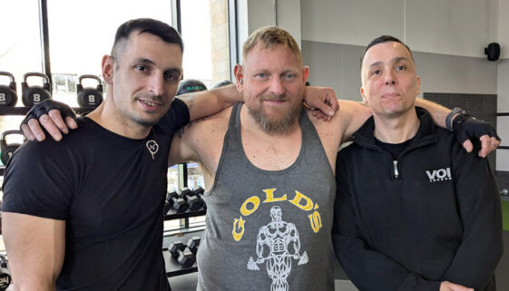 three men together in a gym